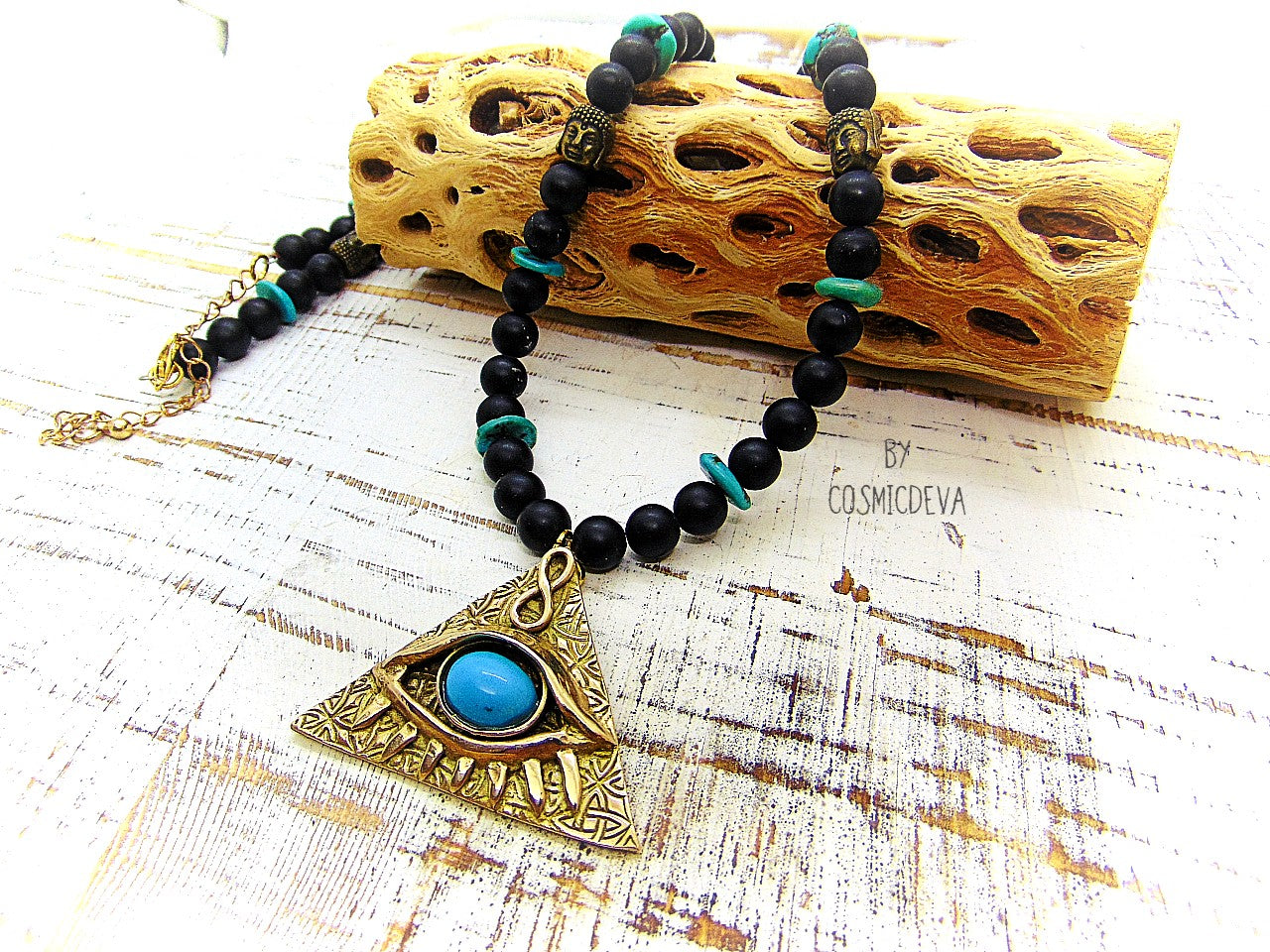 Adorn yourself with this mystical completely hand sculptured bronze All Seeing Eye necklace and protect your soul with its natural turquoise and black onyx gemstones. Feel the spiritual energy of its Infinity symbol and antique brass buddha head beads, inspiring knowledge and positivity. Experience the power of the eye each time you wear it!