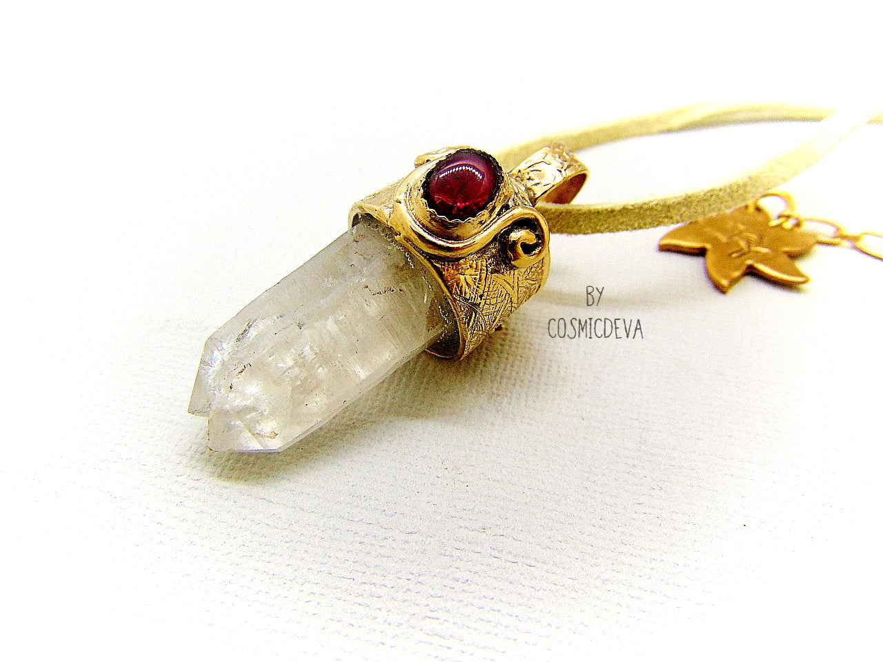 One of a kind completely hand sculptured gold bronze pendant with clear natural twin pointed crystal quartz wand and a lovely red ruby setting. A textured spirit animal dolphin is shown on the backside of the gold bronze pendant. Twin pointed crystals also known as soulmate crystals are two points one body, representing co- in-joined twins or entwined souls. Carry and meditate on a piece of twin pointed quartz to attract your soulmate.