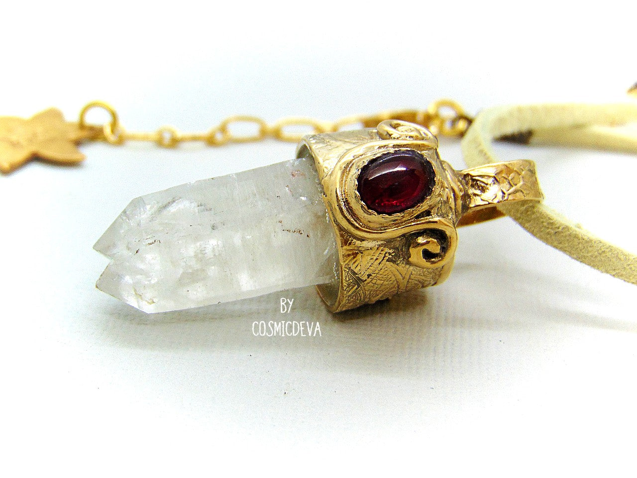 One of a kind completely hand sculptured gold bronze pendant with clear natural twin pointed crystal quartz wand and a lovely red ruby setting. A textured spirit animal dolphin is shown on the backside of the gold bronze pendant. Twin pointed crystals also known as soulmate crystals are two points one body, representing co- in-joined twins or entwined souls. Carry and meditate on a piece of twin pointed quartz to attract your soulmate.