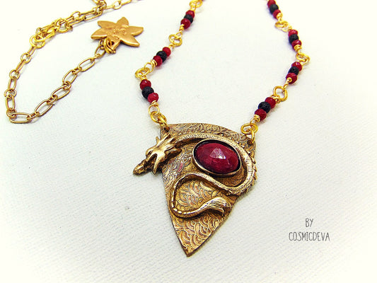 The Dragon is often seen as the guardian of a treasure. The treasure symbolizes you. This beautifully hand sculptured, carved, forged and kiln fired gold bronze talisman pendant with a powerful dragon holding a natural pidgeon blood ruby gemstone.  This Pendant is made of pure high-quality gold bronze. 