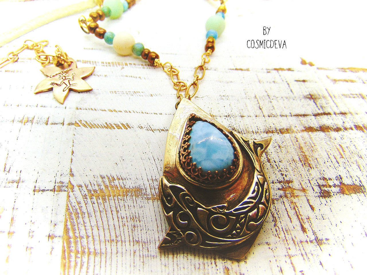 Bring harmony to your life with this beautiful Dolphin Spirit Animal Larimar Bronze Necklace. Handcrafted from solid bronze and adorned with a larimar gemstone, this one-of-a-kind pendant symbolizes the wisdom of Atlantis and healing power of dolphins - sure to bring peace and balance to your life. Finished with white leather and aqua colored jasper and amazonite gemstone beads.