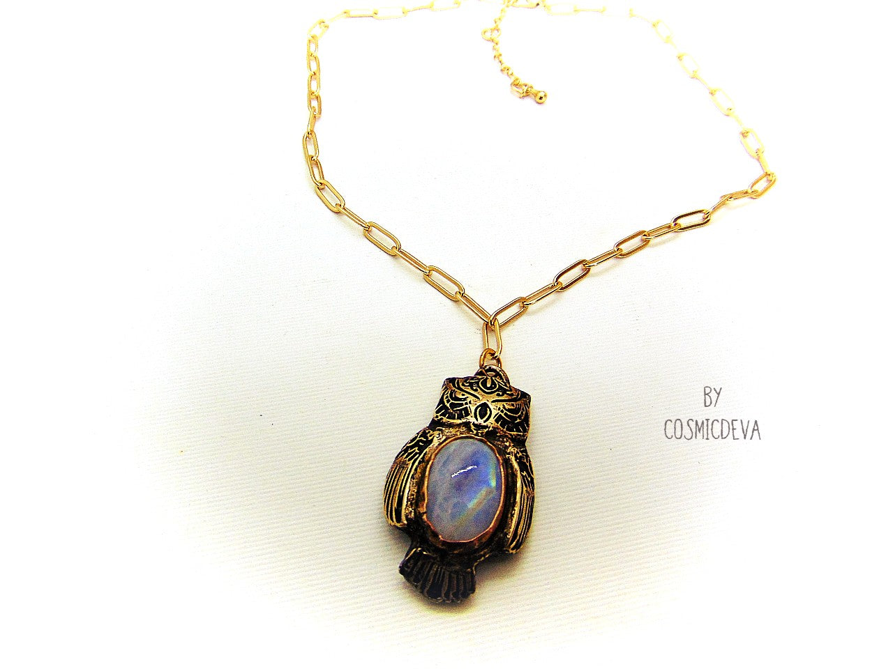 Cute one of a kind complete handcrafted and kiln fired gold bronze spirit animal owl with gorgeous rainbow moonstone bezel setting in the center. The backside of the pendant is also a owl and carries the cosmicdeva logo.