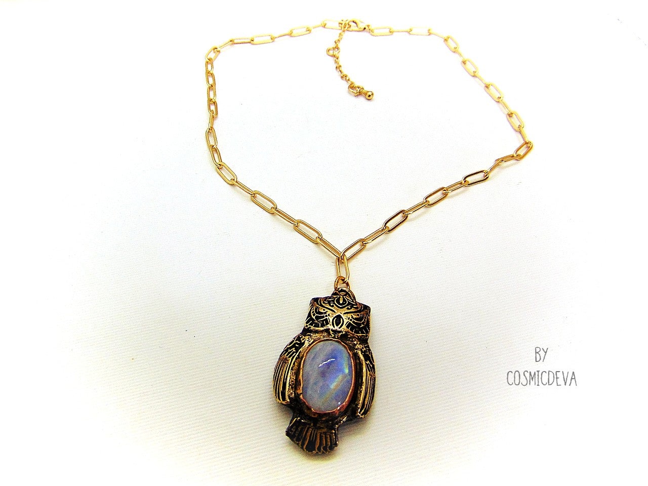 Cute one of a kind complete handcrafted and kiln fired gold bronze spirit animal owl with gorgeous rainbow moonstone bezel setting in the center. The backside of the pendant is also a owl and carries the cosmicdeva logo.