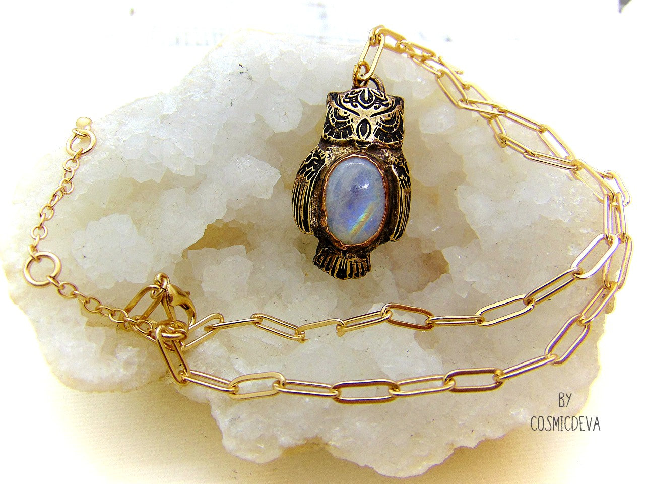 Cute one of a kind complete handcrafted and kiln fired gold bronze spirit animal owl with gorgeous rainbow moonstone bezel setting in the center. The backside of the pendant is also a owl and carries the cosmicdeva logo.