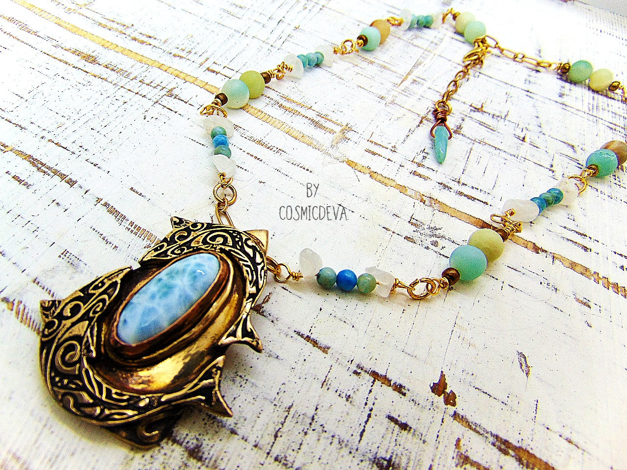Bring harmony to your life with this beautiful Larimar Dancing Dolphins Bronze Necklace. Handcrafted with solid gold bronze and adorned with a dazzling aqua larimar gemstone, this one-of-a-kind pendant evokes the timeless wisdom of Atlantis and the healing power of dolphins. Finished with aqua jasper, clear quartz and amazonite gemstone beads, this necklace is a stylish and meaningful choice!