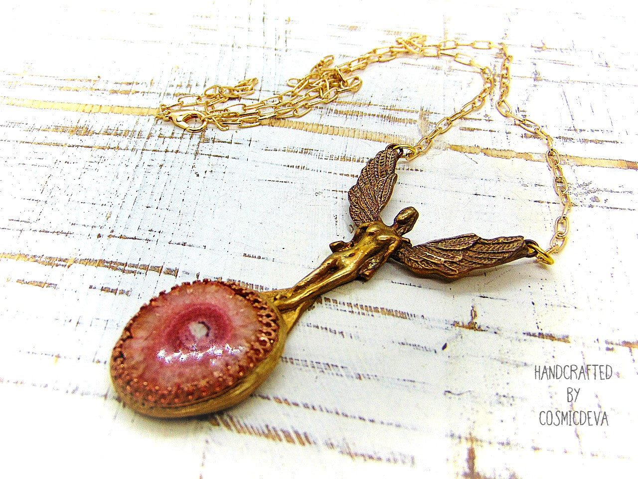 Be divinely inspired wearing this unique Archangel Chamuel pendant necklace. Handcrafted from gold bronze, it features a pink solar quartz bezel setting and is charged with the pink angel light ray of Kamael, the Archangel of peaceful relationships. Energize your spirit and look beautiful 