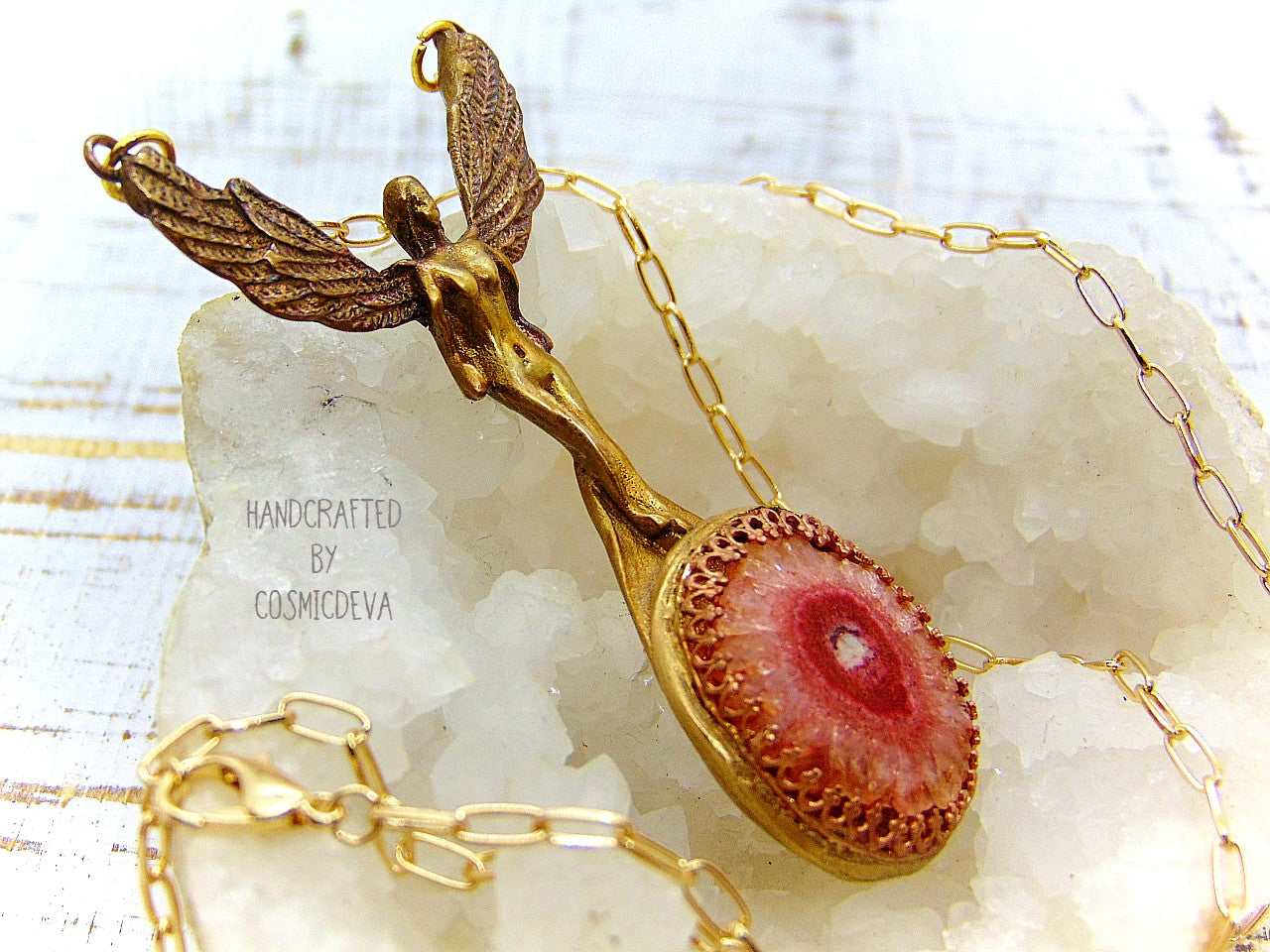 Be divinely inspired wearing this unique Archangel Chamuel pendant necklace. Handcrafted from gold bronze, it features a pink solar quartz bezel setting and is charged with the pink angel light ray of Kamael, the Archangel of peaceful relationships. Energize your spirit and look beautiful 