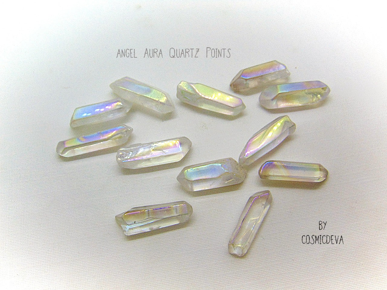 Lovely shimmering iridescence Angel Aura Quartz crystal points.  Angel Aura Quartz is natural clear quartz with an infusion of pure titanium, silver and gold. The Natural Clear Quartz Point is placed in a pressurized chamber at high temperature and exposed to pure vaporized precious metal. 