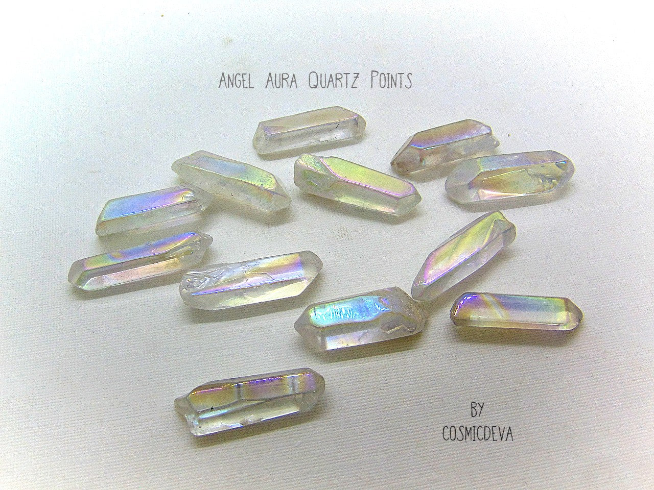 Lovely shimmering iridescence Angel Aura Quartz crystal points.  Angel Aura Quartz is natural clear quartz with an infusion of pure titanium, silver and gold. The Natural Clear Quartz Point is placed in a pressurized chamber at high temperature and exposed to pure vaporized precious metal. 