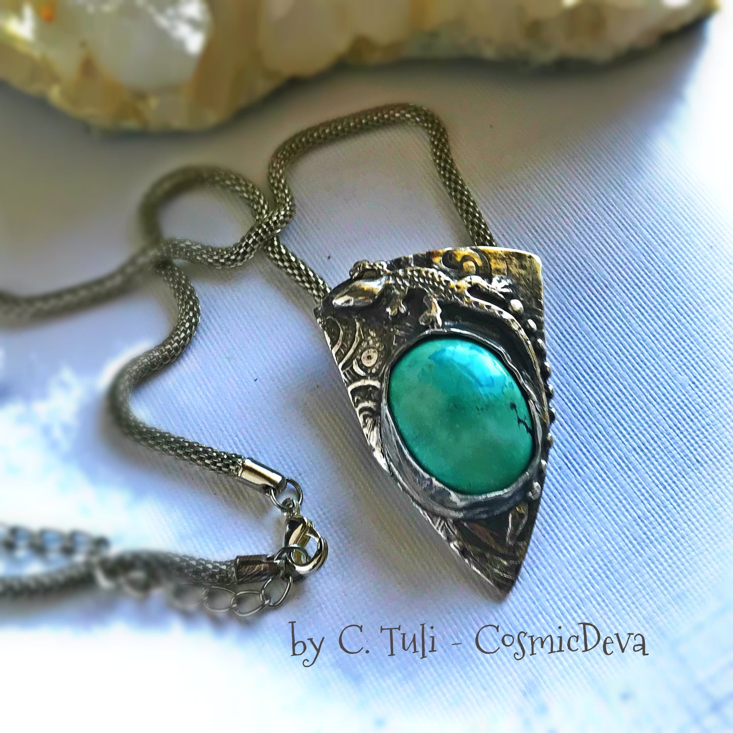Sterling Silver Lizard Gecko Turquoise Pendant Necklace. Beautiful completely handcrafted pure sterling silver pendant with a Arizona turquoise gemstone cabochon. This unique statement piece is designed with a lizard/ gecko southwest style. It is hallmarked as Sterling Silver and carries my artisan Cosmicdeva logo.    The necklace is a 16 inch (40.6 cm) woven wire silver tone alloy. - CosmicDeva