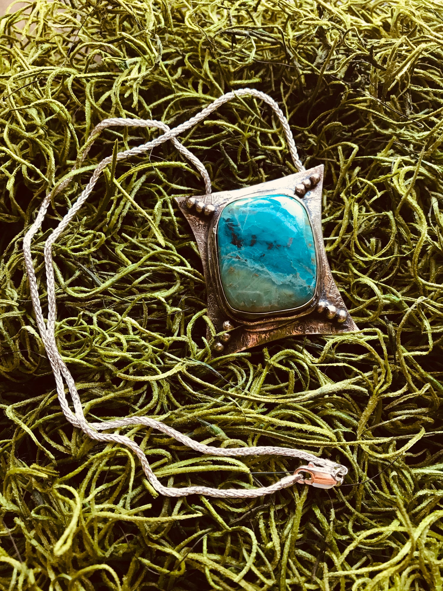 One of a kind fully handmade sterling silver art jewelry necklace with a spectacular vibrant blue green Chrysocolla (a.k.a "Peruvian Turquoise") stone. The polished sterling silver pendant was oxidized to give it an antique look. This unique creation balances from an 18-inch sterling silver 1.6mm wheat chain.